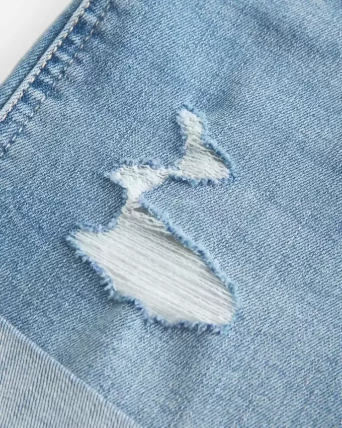 High-Rise Ripped Medium Light Wash Denim Shortie Shorts